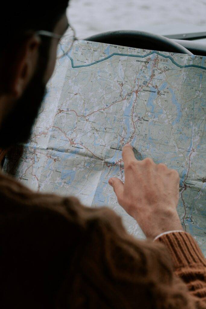 Person pointing at a paper map