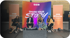 Four people sitting in front of a BBC share your story panel