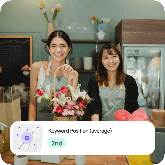 Two women smiling with a basket of flowers and keyword position (average) box at the bottom